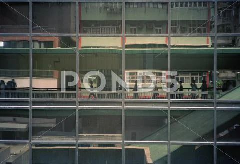 A building with reflections of city life on the facade, Hong Kong, China Stock Photos