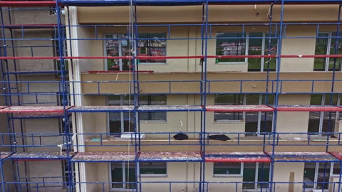 Building renovation progress. Exterior upgrade on residential structure with Vídeos de archivo 340151415