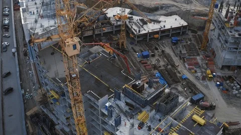 Building a residential house process in modern cityscape. Aerial Stock Footage 98742786