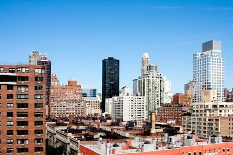 Building rooftops under blue sky Stock Photos