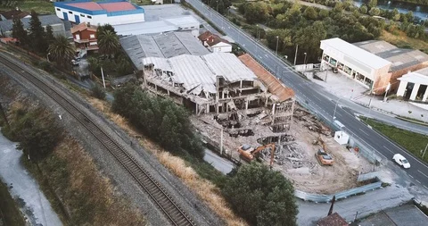 BUILDING IN RUINS BETWEEN TRAIN RAIL AND ROAD Stock Footage 91631862