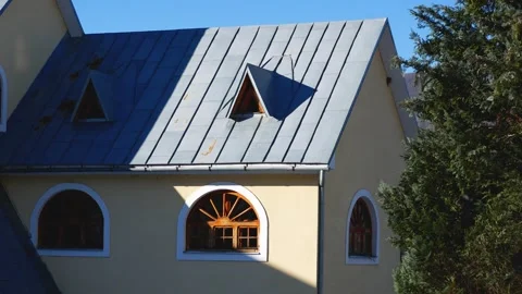 A building with semicircular windows and a pointed roof. In the foreground is a Stock Footage 273171886