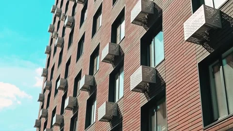 A building with several balconies is visible against a bright sky filled with Video stock 338447009