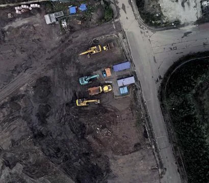 Building site aerial looking down over construction vehicles in dirt field Fotos de archivo