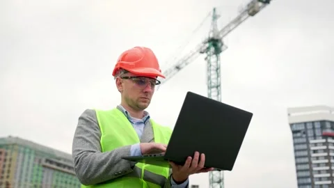 Building site inspector working on portable computer during on-site audit Video stock 274392609