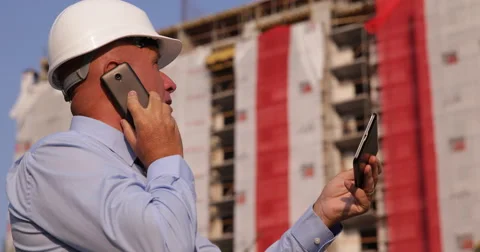 Building Site Manager Inspect Construction Stage Talk to Mobile and Use Tablet Video stock 66903068