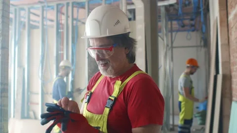 Building site worker resting and using mobile phone Stock Footage 133639147