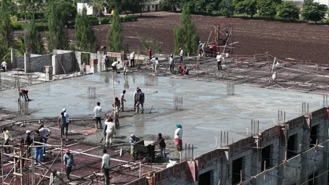 Building Site Workers Spreading Concrete Mixture for Floor Slab Casting Stock Footage 344477637