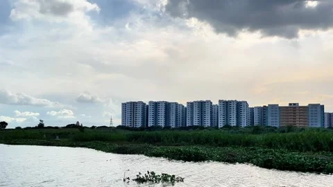 Building, sky &amp; river water flow l Cityscape Meets Nature Stock-Footage 311697094