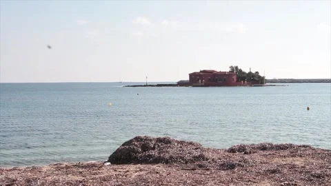 Building on small island in water ocean off coast Stock-Footage 252153269
