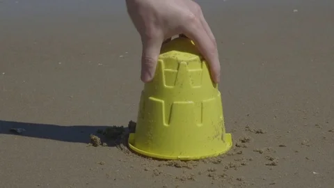 Building Small Sandcastles with Ocean Waves Crashing on the Beach Vídeo Stock 74367008