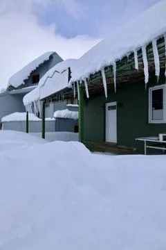 A building with snow on the ground Stock Photos