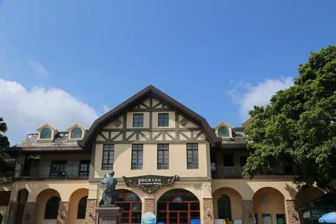A building with a statue of a man on the front Stock Photos