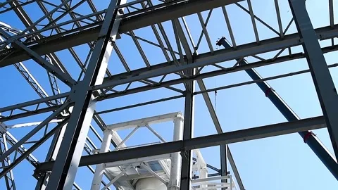 A building structure made of metal beams forming the frame of a building or.. Video stock 331205928