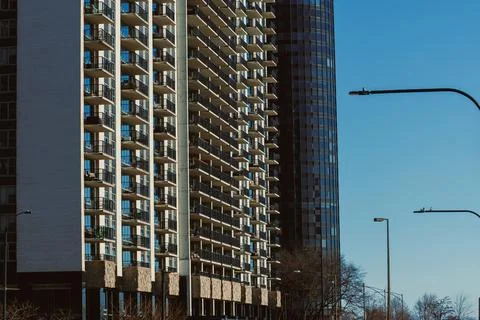 Building structures rise in a city under clear blue sky with street lights .. Stock-Fotos