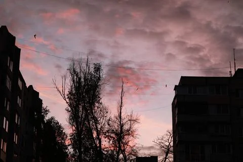 A building with a sunset in the background Stock Photos