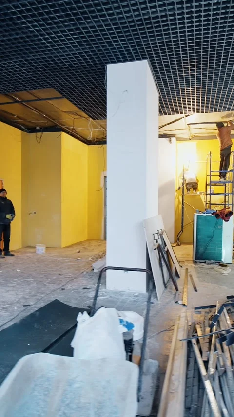 Building team working inside the large unfinished premise. Materials and Stock Footage 337717326