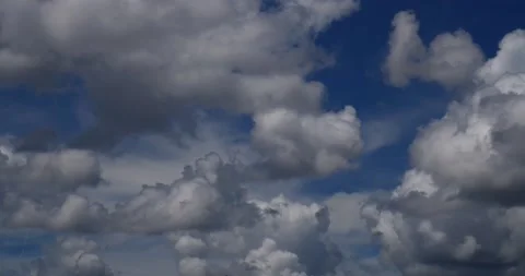 Building thunderstorms move away from camera under deep blu sky time lapse Stock Footage 152528993