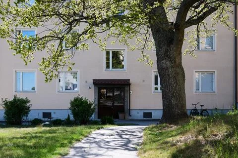 A building with a tree in front of it Stock Photos