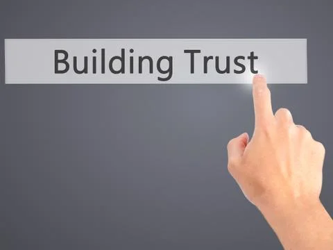 Building Trust - Hand pressing a button on blurred background concept on visu Foto stock
