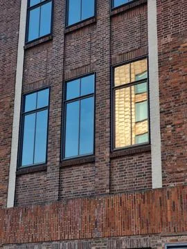 A building with two windows reflecting a building in the window Fotos de archivo