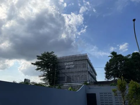 Building under cloudy blue sky Stock Photos