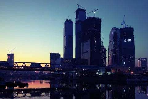 Building under construction and the setting sun and sky at background Stock Photos