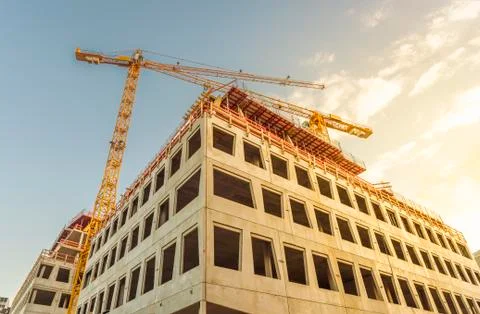 Building under construction and tower crane Stock Photos