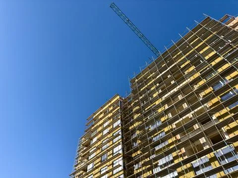 Building under construction with blue sky in background Stock Photos
