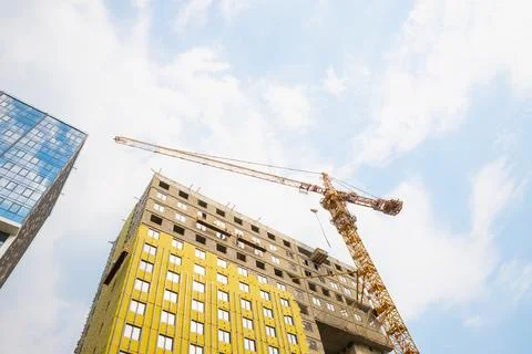 Building under construction, construction crane. mineral wool house insulation Stock Photos