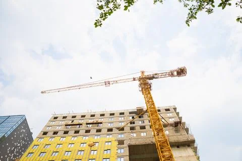 Building under construction, construction crane. mineral wool house insulation Stock Photos