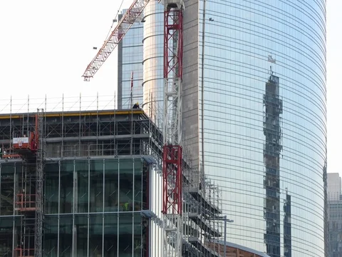 Building under construction with construction men at work Stock Footage 71992827