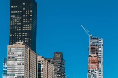 Building under construction with Crane on a Building in New York City on a blue Stock Photos