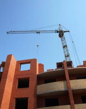 Building under construction with crane Stock Photos