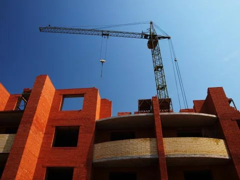 Building under construction with crane Stock Photos