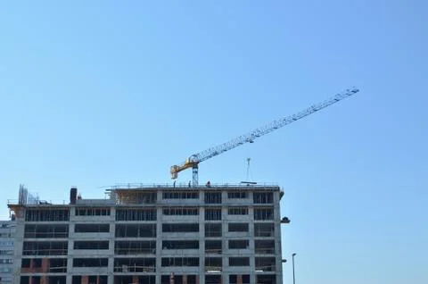 Building under construction with a crane Stock Photos
