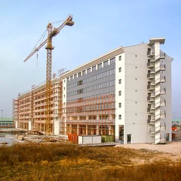 Building under construction with crane Stock Photos