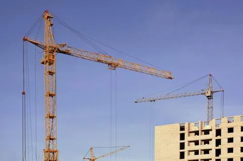 Building under construction with crane Stock Photos