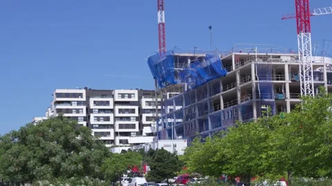 Building under construction with crane in an urban area Stock Footage 335484960