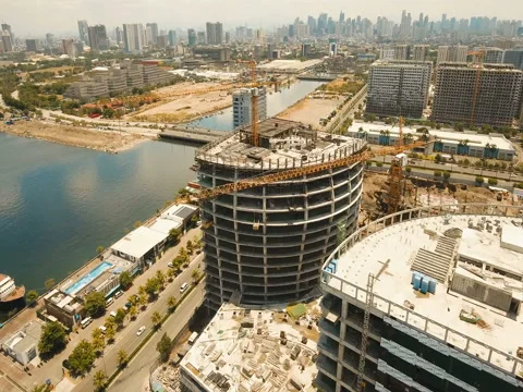 Building under construction with cranes in the city. Philippines, Manila, Makati Stock Footage