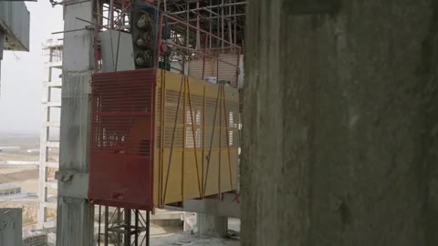 Building under construction elevator for workers Stock Footage 308495719