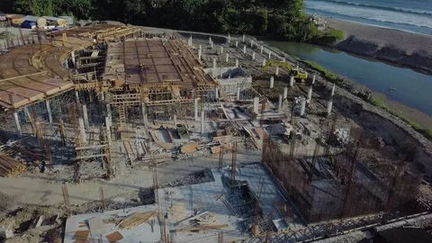 Building under construction on the ocean cost aerial footage flight around Stock Footage 100692828
