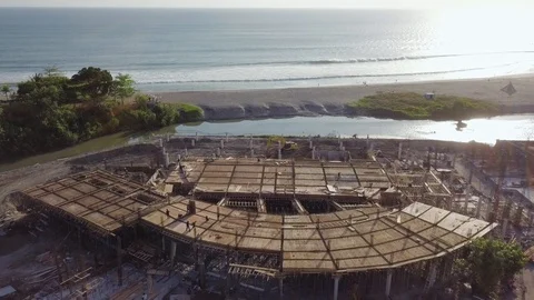 Building under construction with the ocean view sunset time aerial footage Stock Footage 100692841