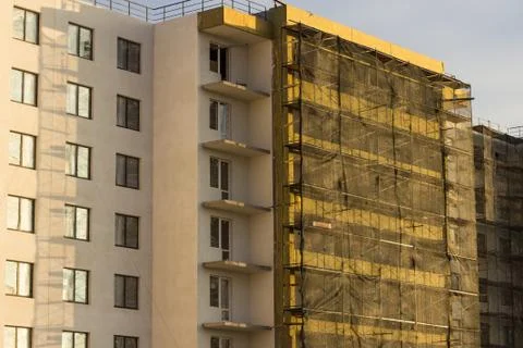 Building under construction in scaffolding Stock Photos