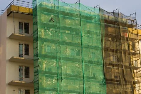 Building under construction in scaffolding Stock Photos