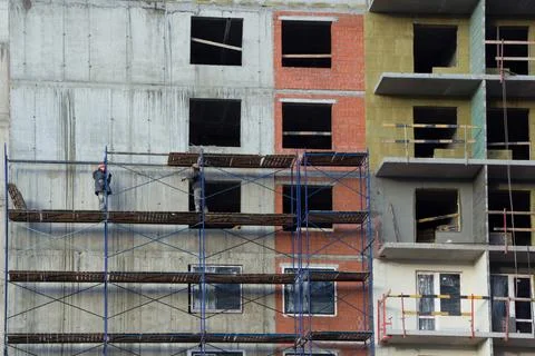 Building under construction in scaffolding Stock Photos