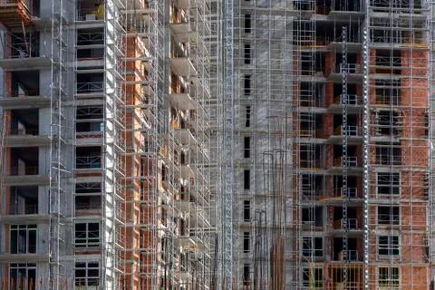 Building under construction with scaffolds background Foto stock