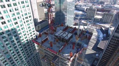 Building under construction surounded by skyscrapers Video stock 64143473