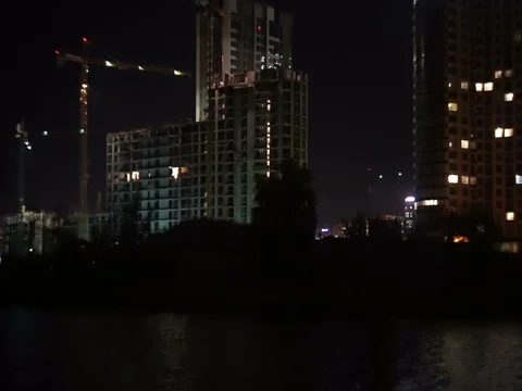 Building under construction, view from the river at night Stock Footage 71861570