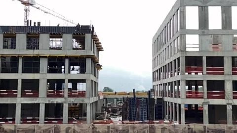 Building under construction working crane driving big trucks concrete mixer Stock Footage 159709442